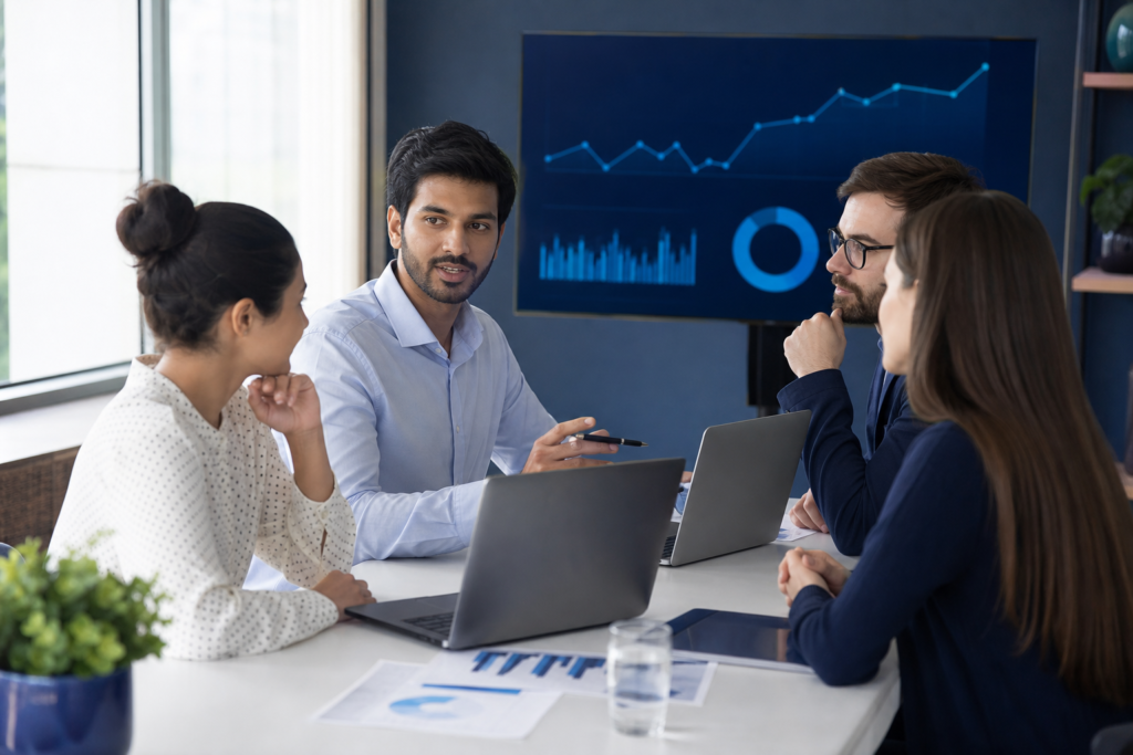 Startup team reviewing website ROI planning and performance metrics in a modern office